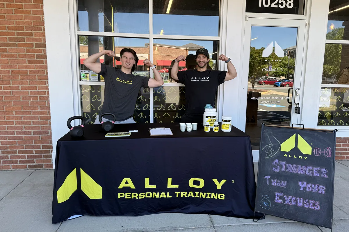 Alloy Personal Training coaches at a community table outside the 10258 Main St studio in Fairfax City, VA