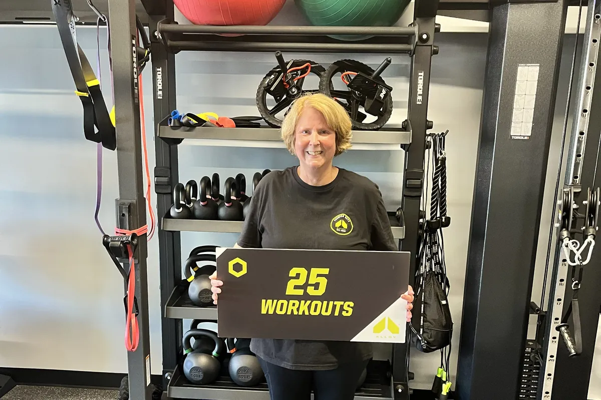 Member celebrating 25 workouts at Alloy Personal Training Fairfax City
